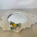 Ceramic mirror with serrated edge and a flower