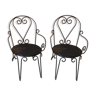 Pair of old garden chairs in wrought iron with volutes