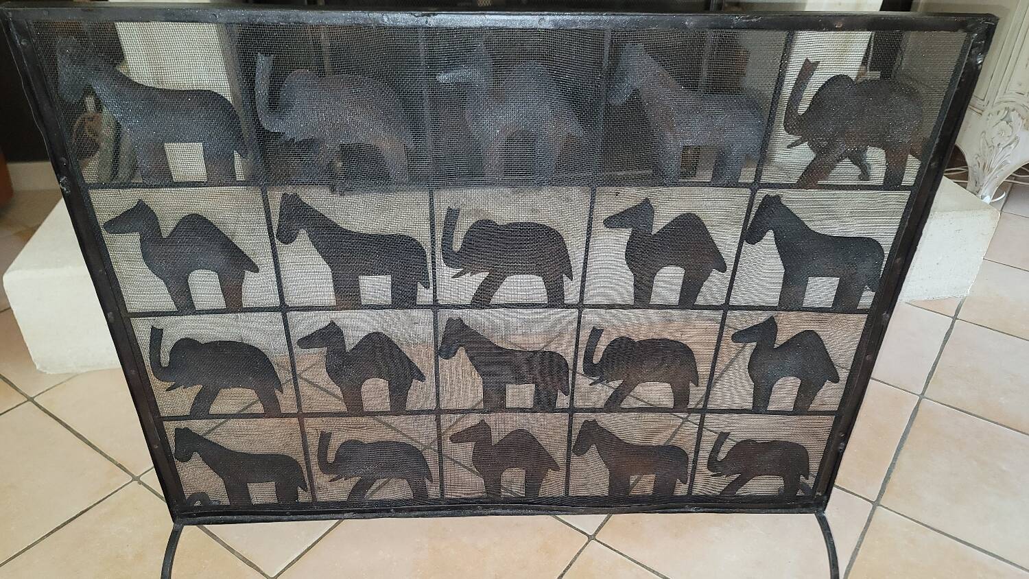 Black metal firewall decorated with animals
