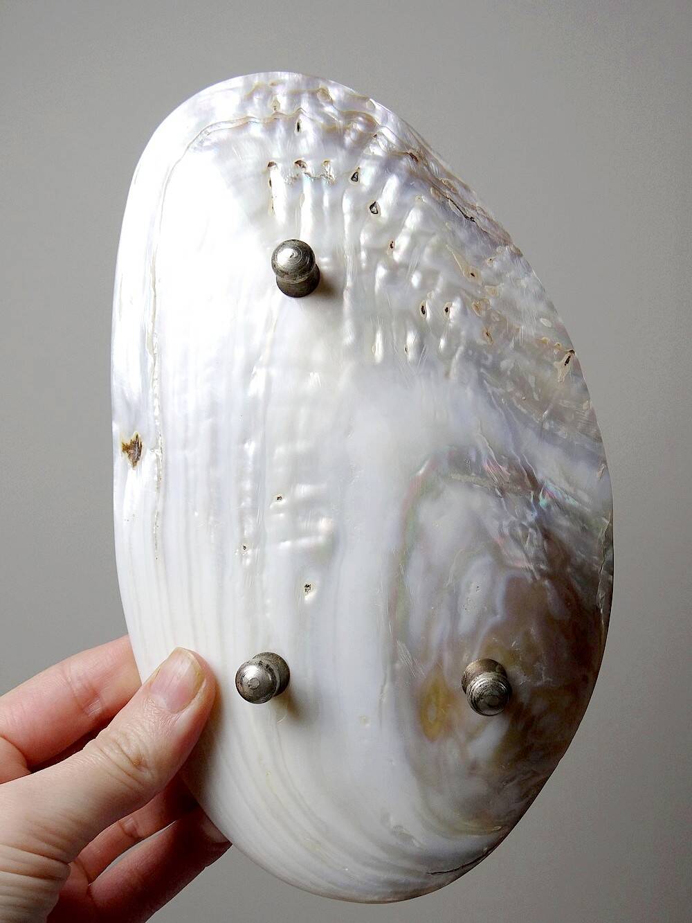 Antique mother-of-pearl tripod bowl emptier with silver metal legs