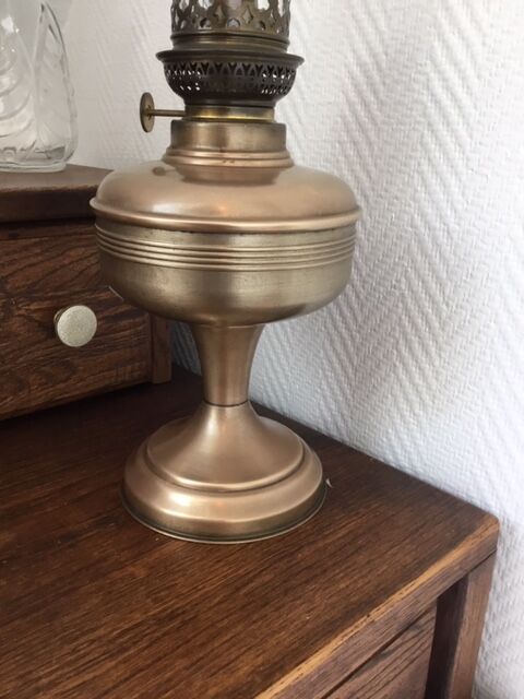 Old oil lamp on pink copper stand