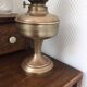 Old oil lamp on pink copper stand