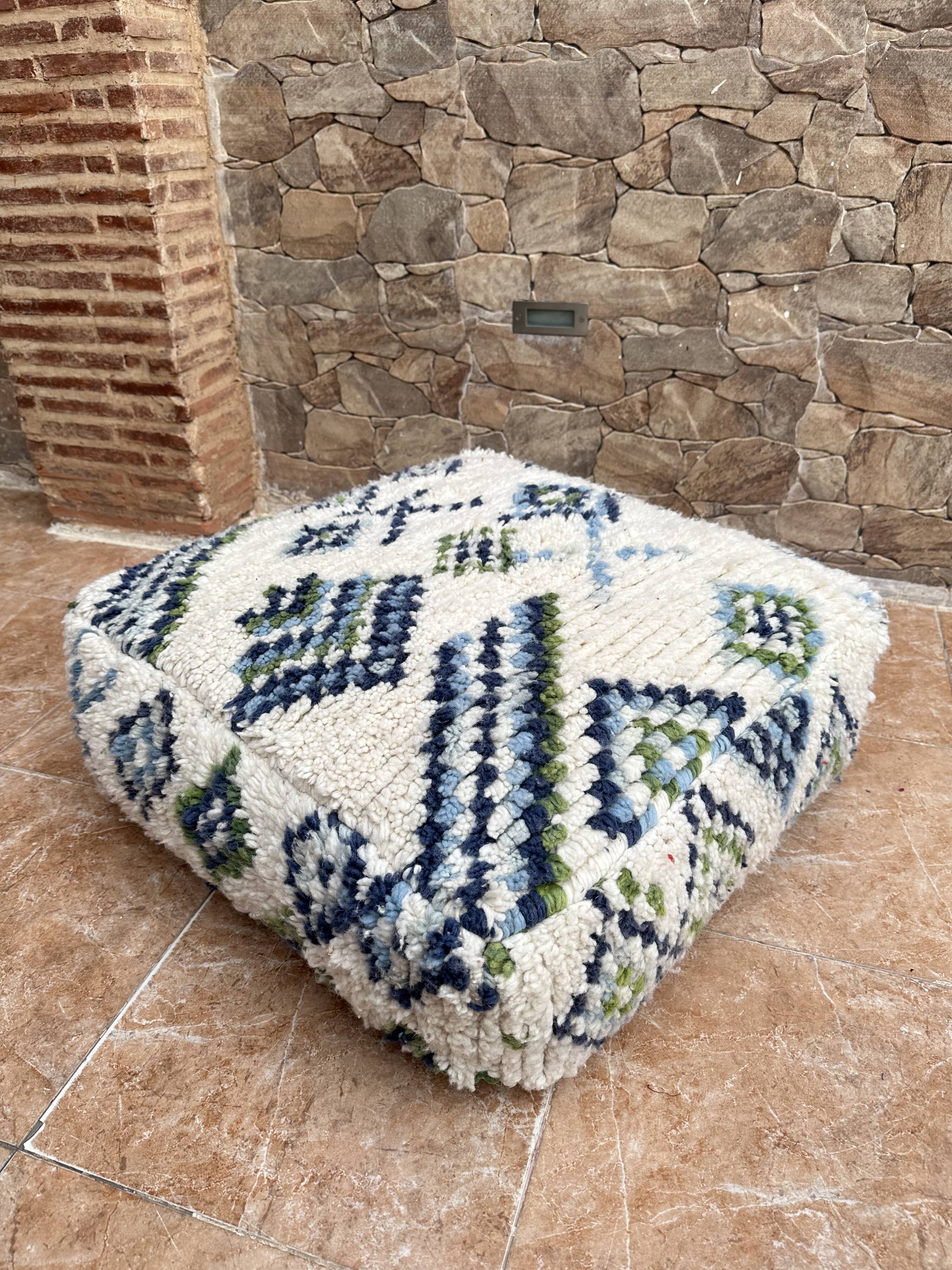 Berber floor pouf: Handwoven Moroccan wool cushion.