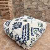 Berber floor pouf: Handwoven Moroccan wool cushion.