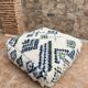 Berber floor pouf: Handwoven Moroccan wool cushion.