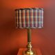 Lamp base in gilded brass, oval silk lampshade with a checkered pattern in burgundy.