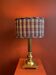 Lamp base in gilded brass, oval silk lampshade with a checkered pattern in burgundy.