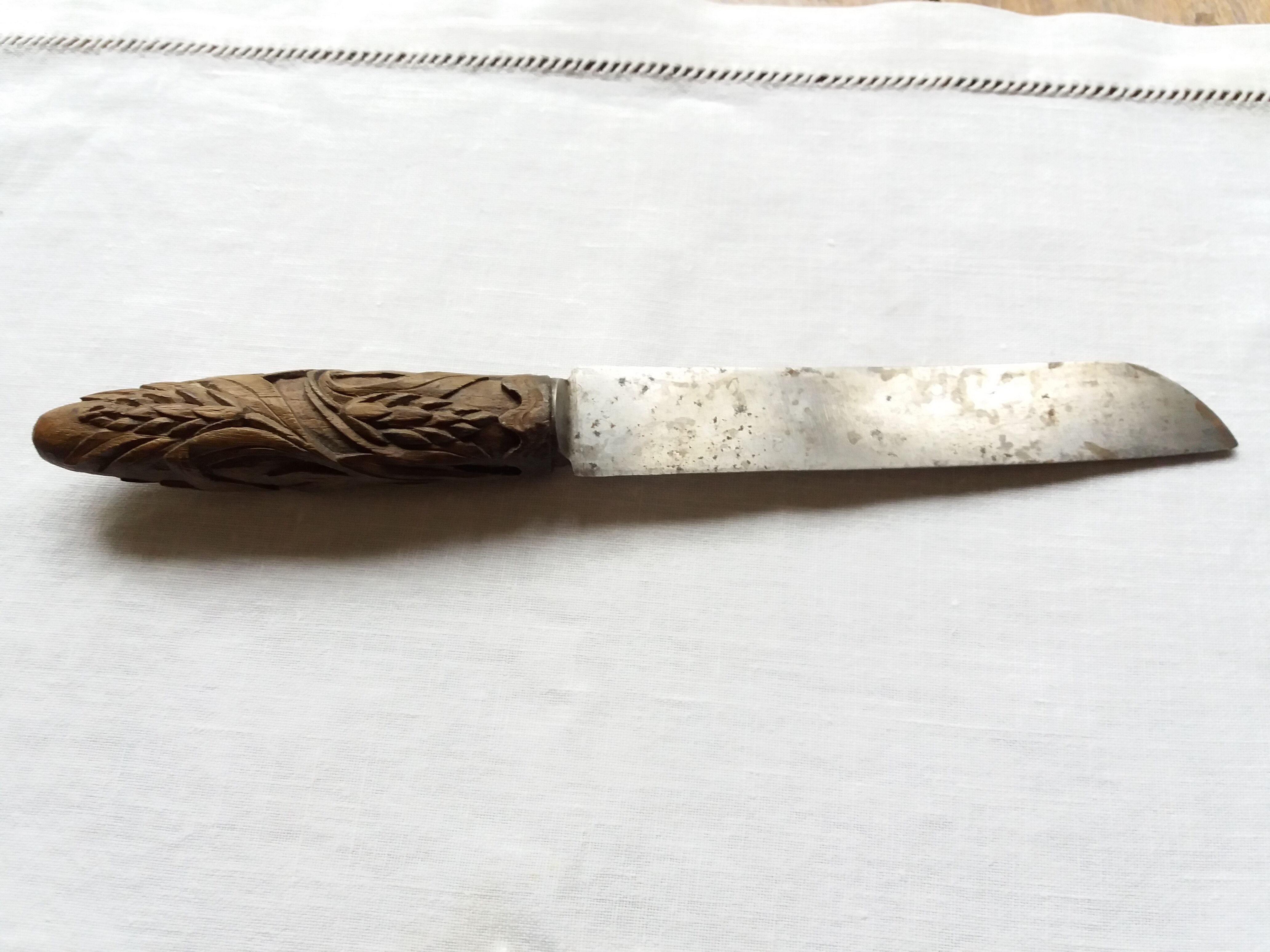Old bread knife with a carved wooden handle