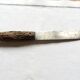Old bread knife with a carved wooden handle