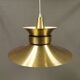 Large hanging lamp, made of brass-coloured aluminium with red and white contrast lacquer inside.