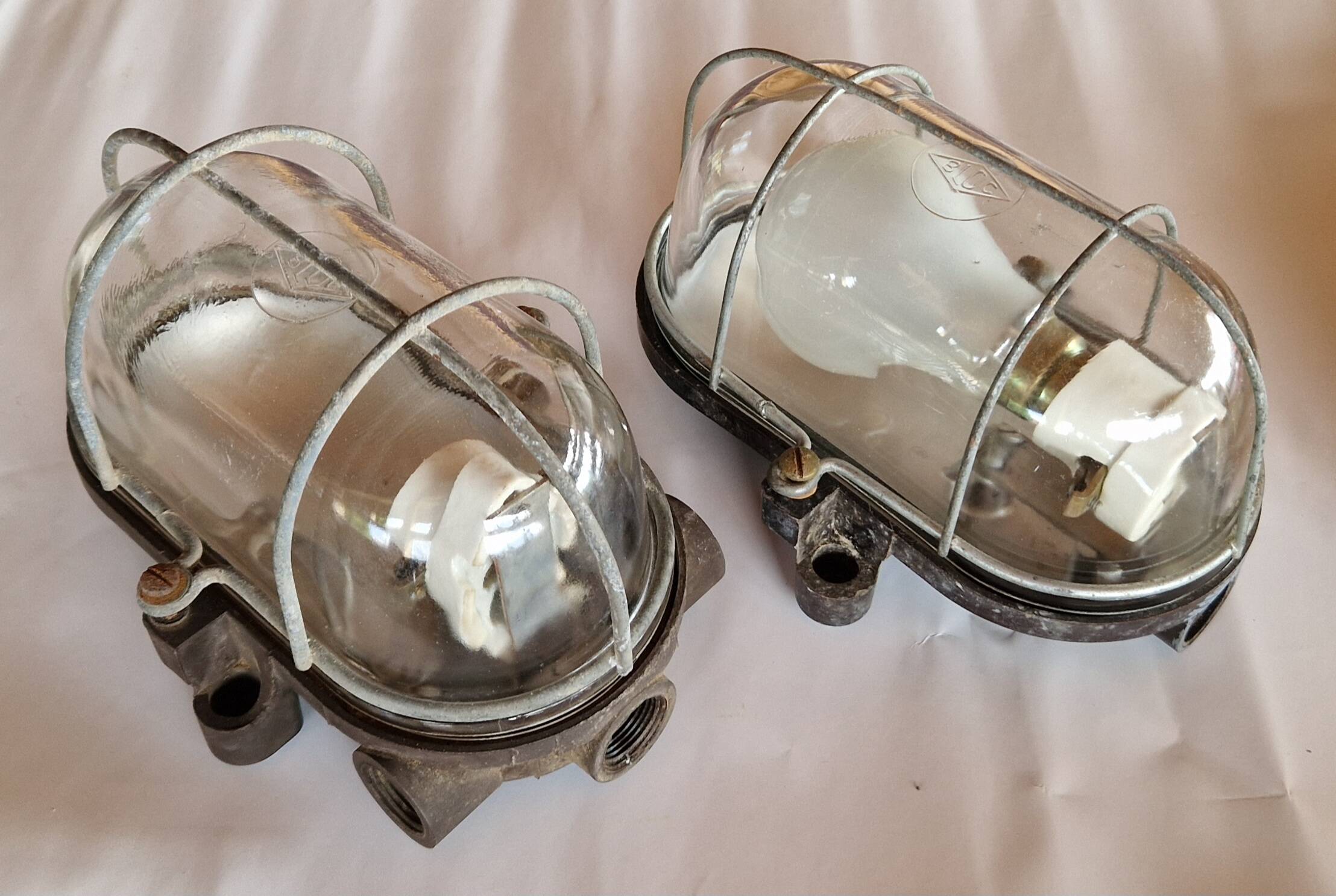 Pair of oval porthole wall lights in bakelite and glass