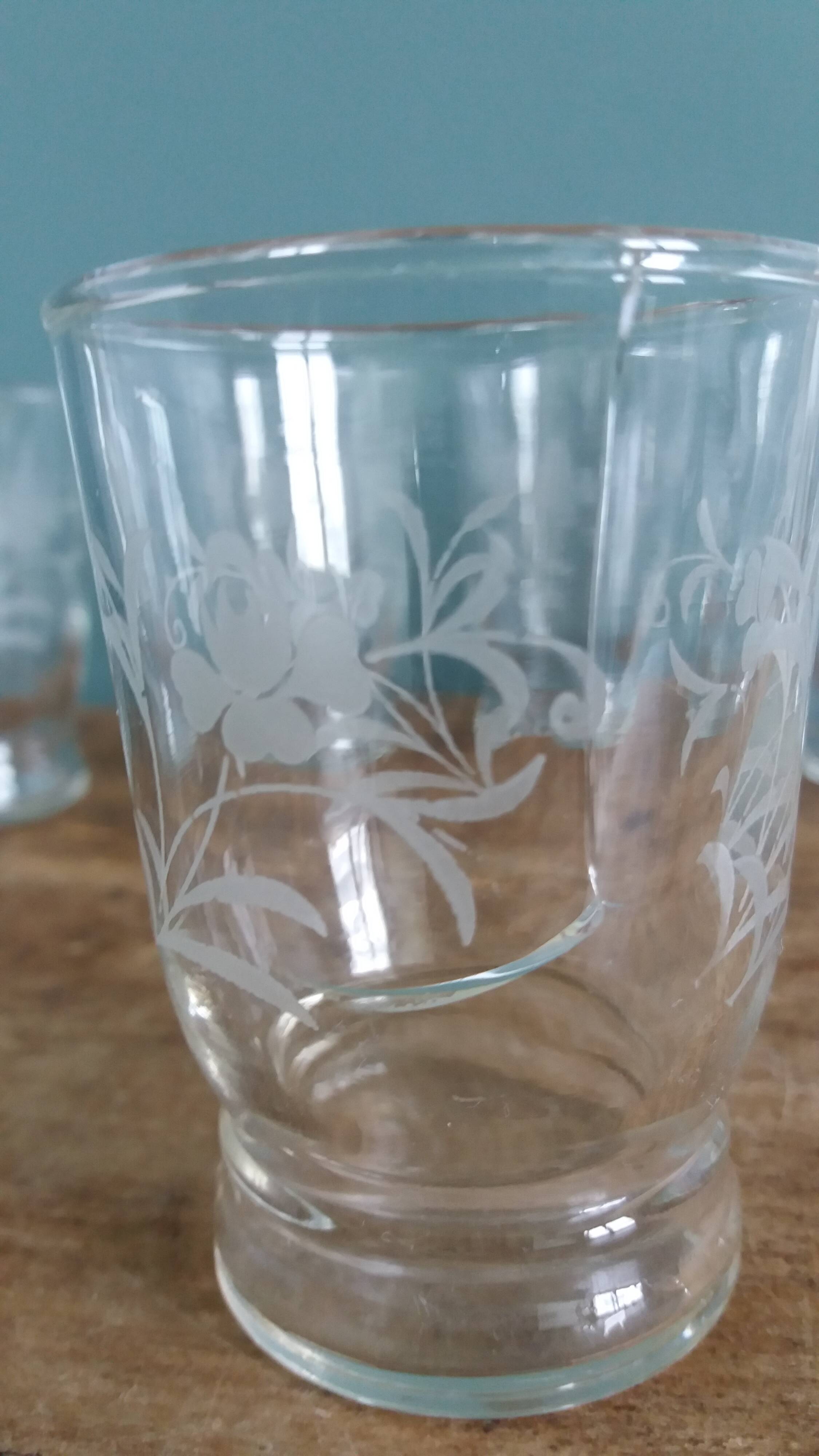 Old digestif or liqueur glasses, handcrafted glass with a floral pattern.