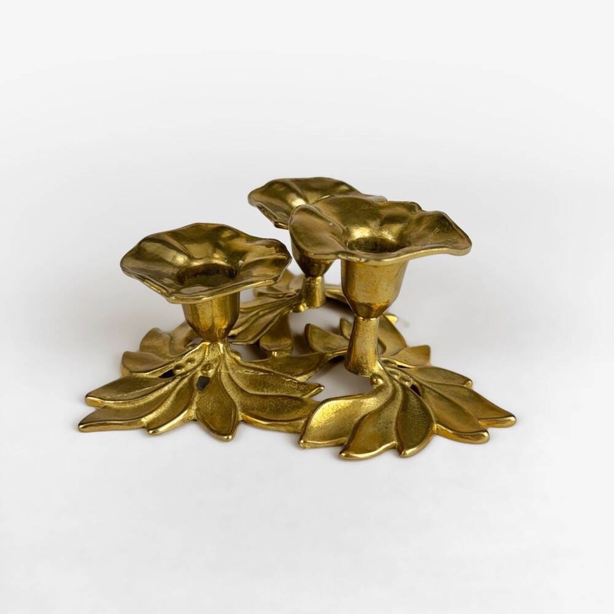 Art Nouveau style three-flower brass candle holder
