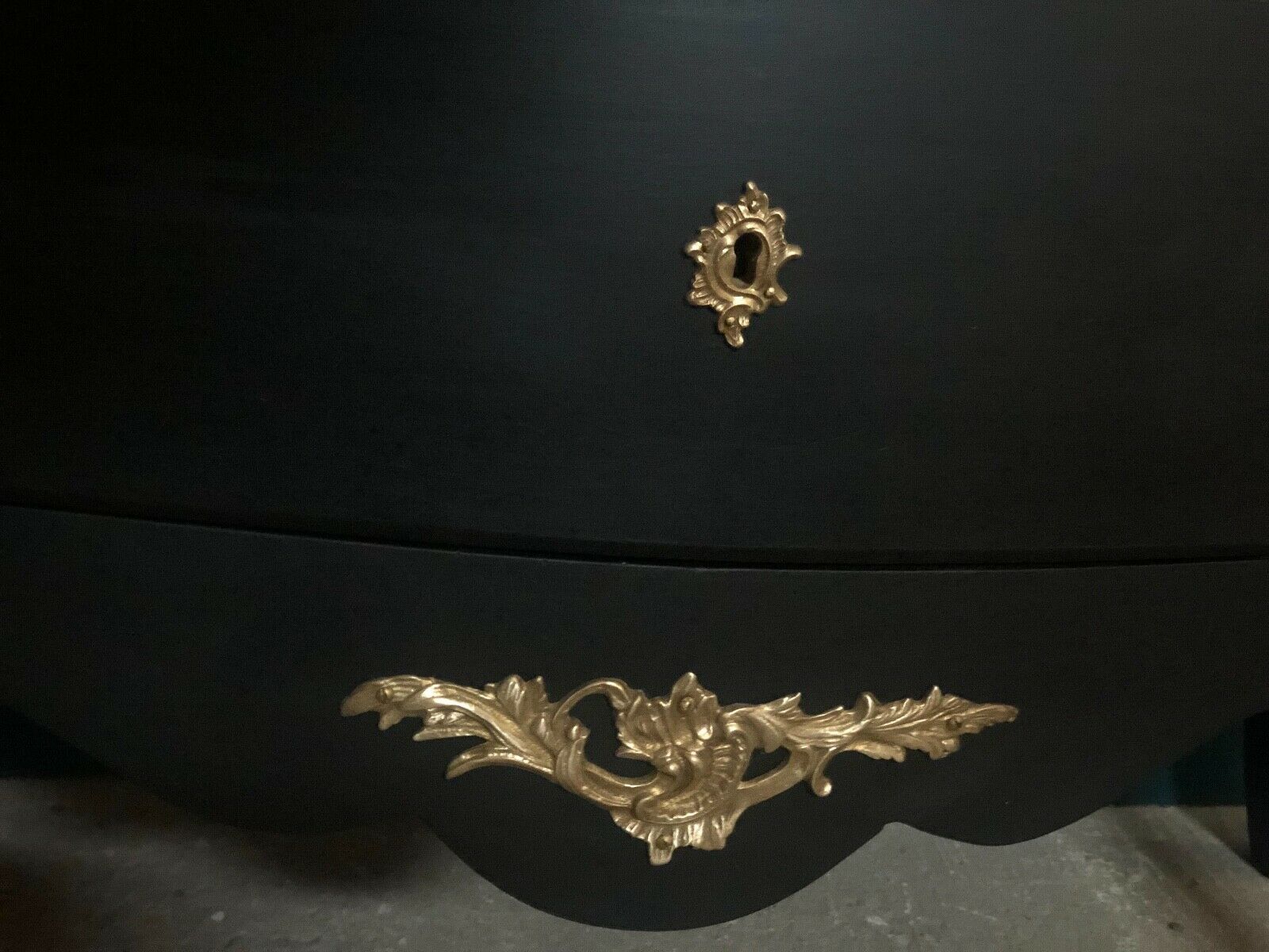 Louis XV style curved black matte commode with gilded bronze ornamentation from the 1950s.