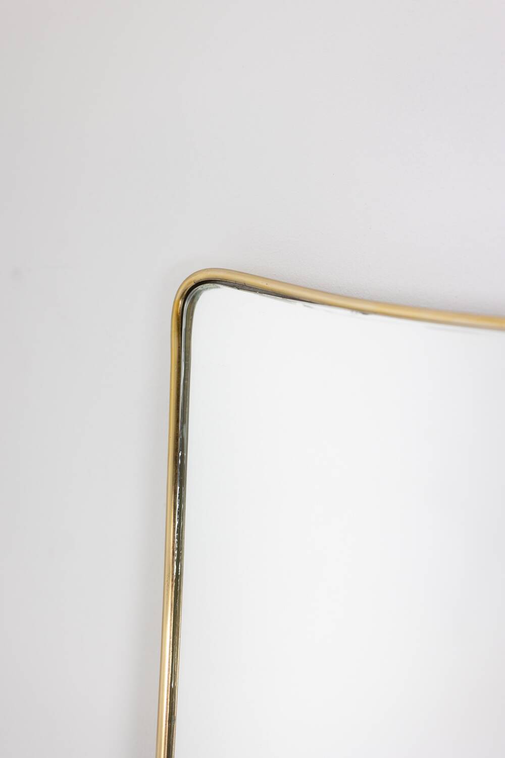 Pair of narrow gilt brass mirrors. Circa 1970.