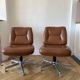 Pair of cognac-colored swivel armchairs