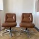 Pair of swivel armchairs in cognac colour.