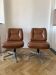 Pair of swivel armchairs in cognac colour.