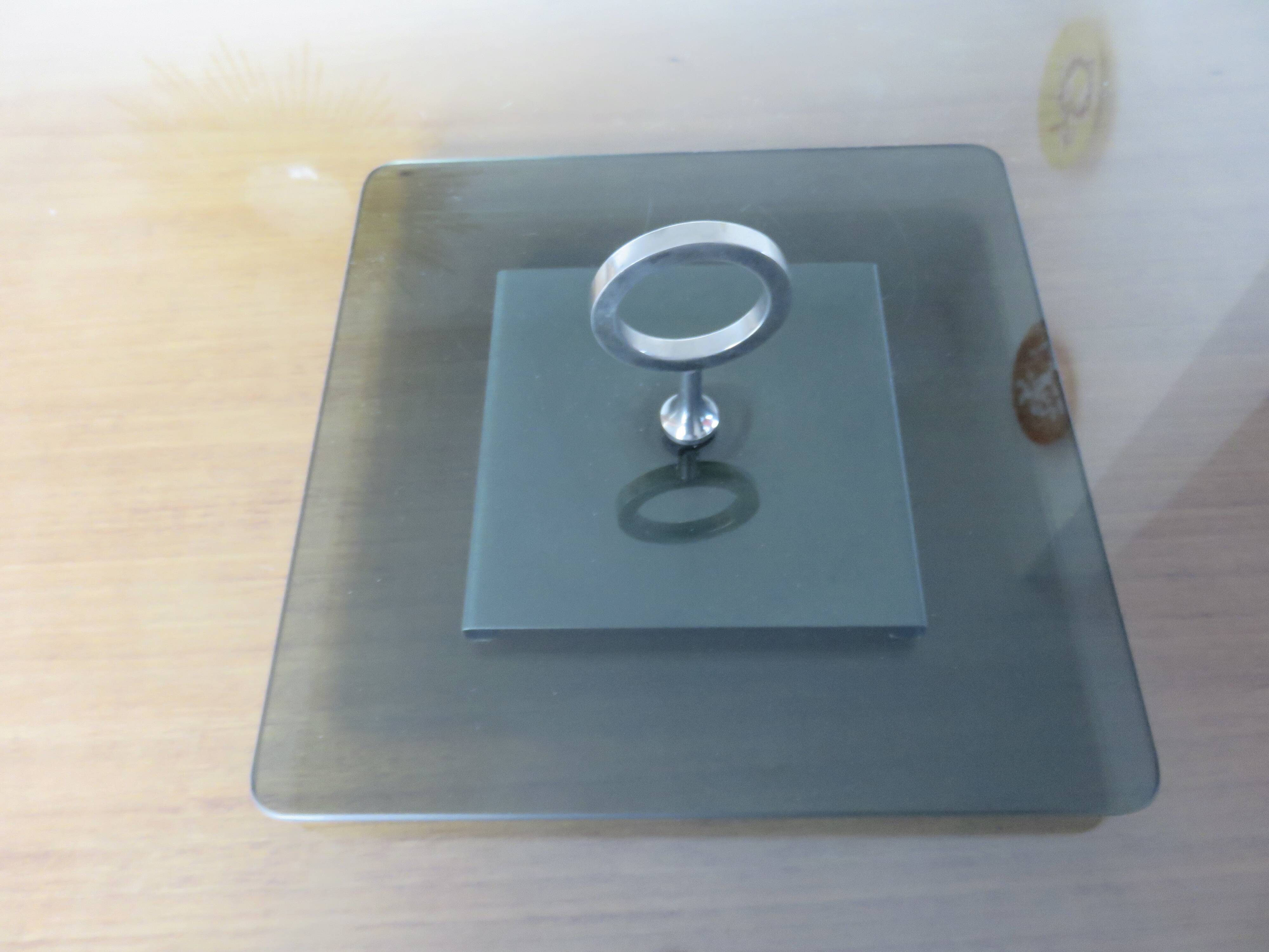 Modernist revolving serving tray, in smoked glass and silver-plated metal, 70.