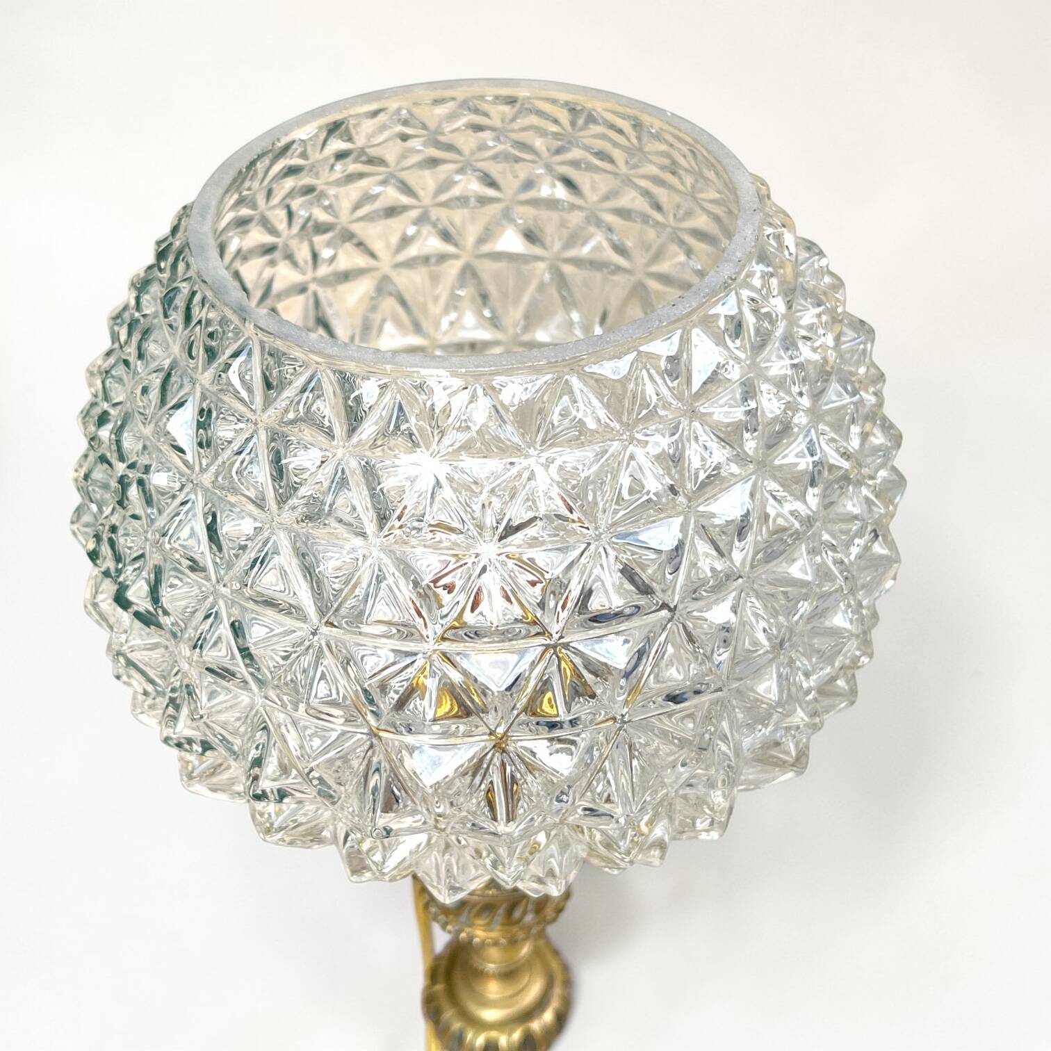 Antique brass foot lamp with glass globe and diamond point.