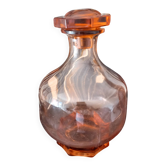 Vintage glass carafe in pink-orange, retro-chic style.