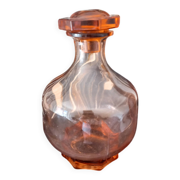 Vintage glass carafe in pink-orange, retro-chic style.