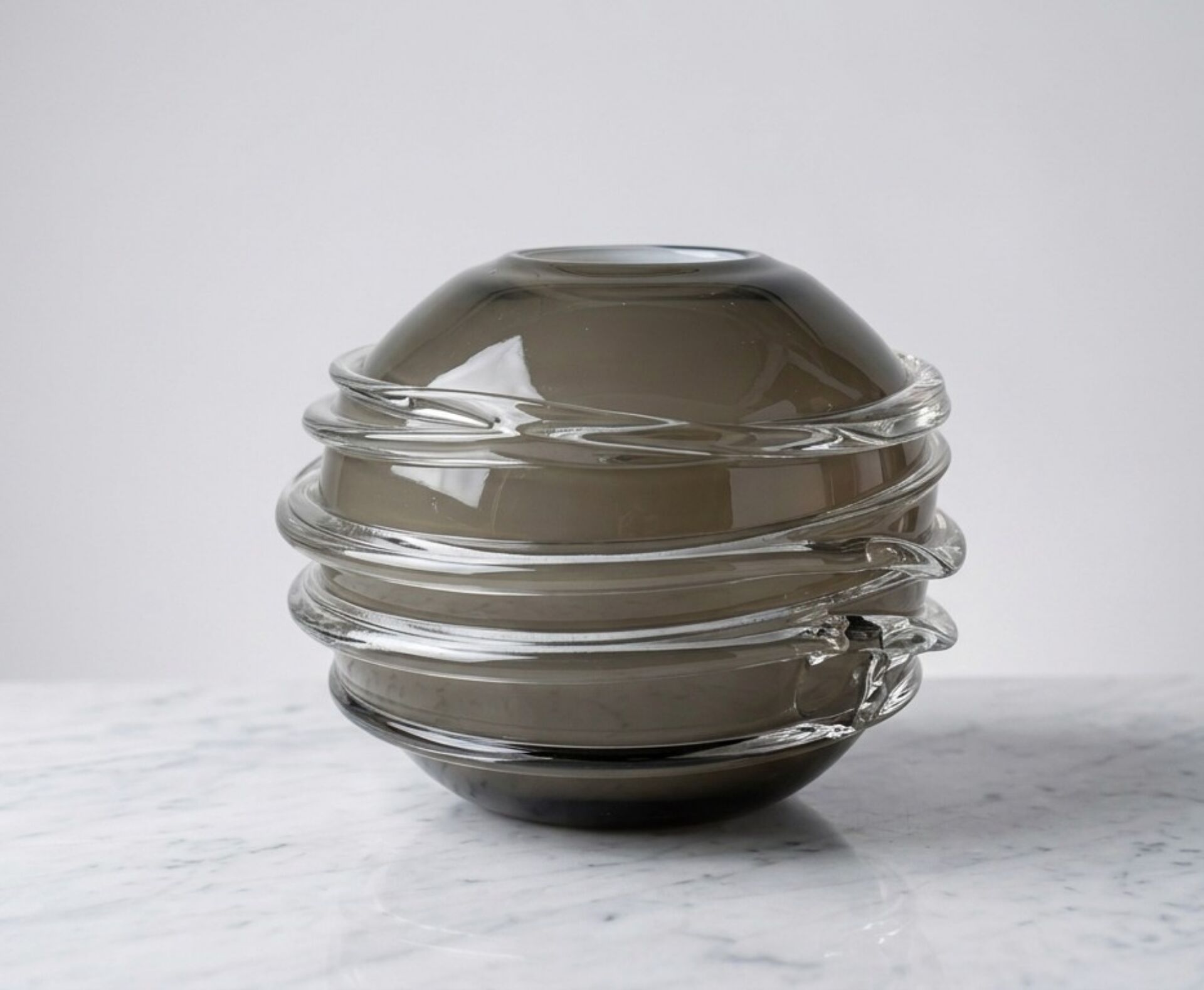 Smoky glass spherical vase with spiral applications from the 1970s.