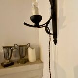 Two wrought iron wall lights, fabric cable.