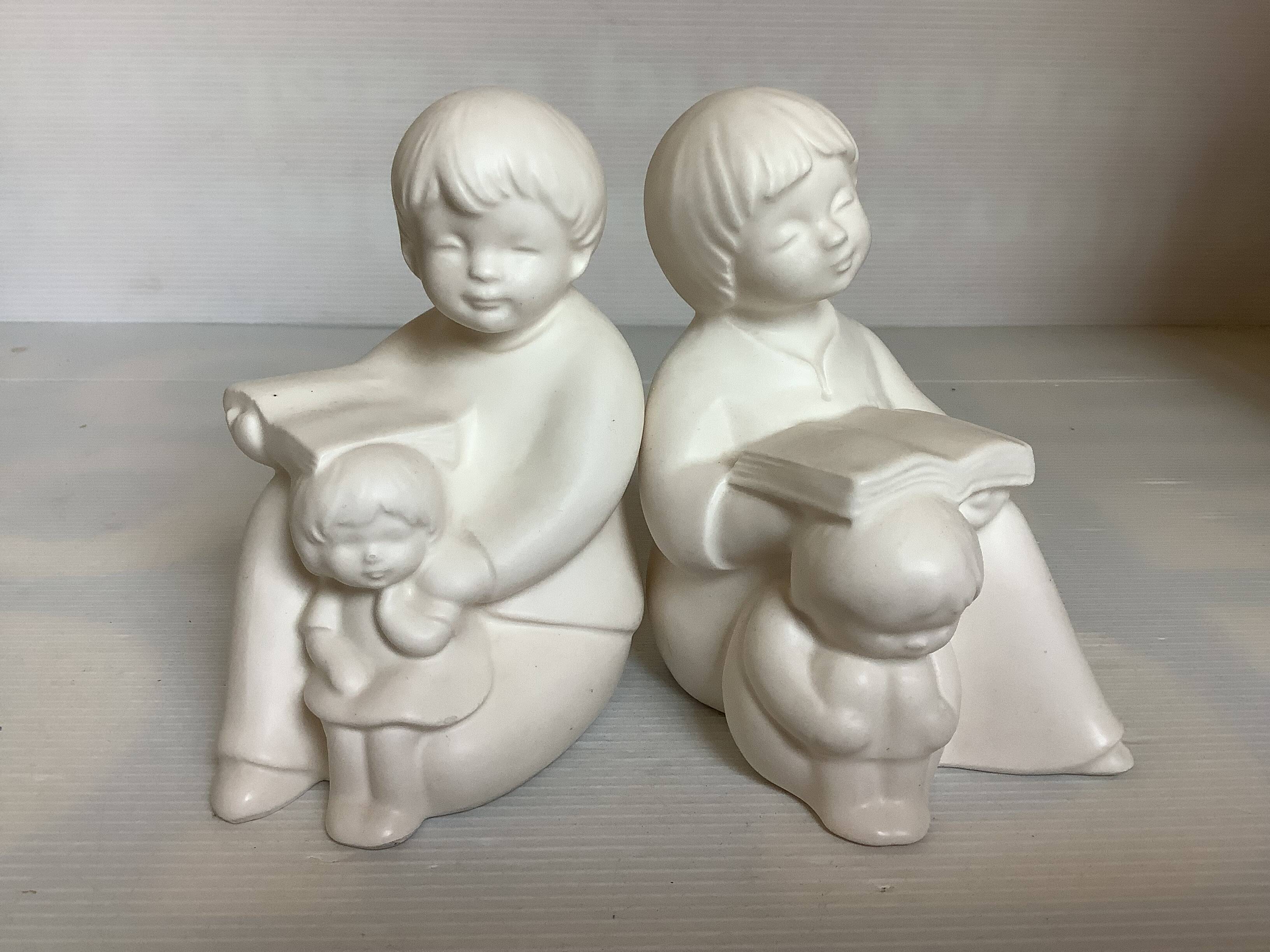 Pair of bookends with a matte white glaze for children.