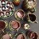 Large service in green and brown glazed stoneware with facets, signed Louis Cag.