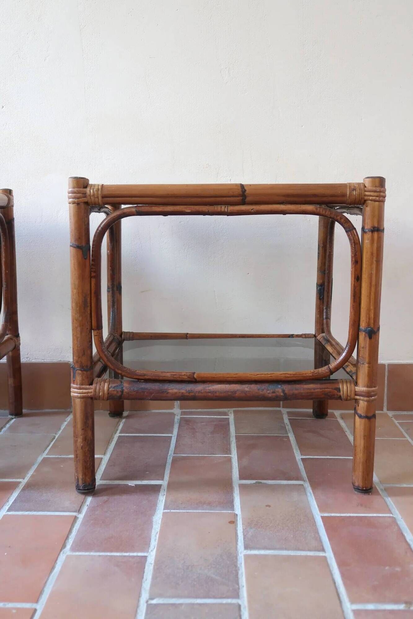Pair of bamboo and rattan bedside tables, smoked glass tops.