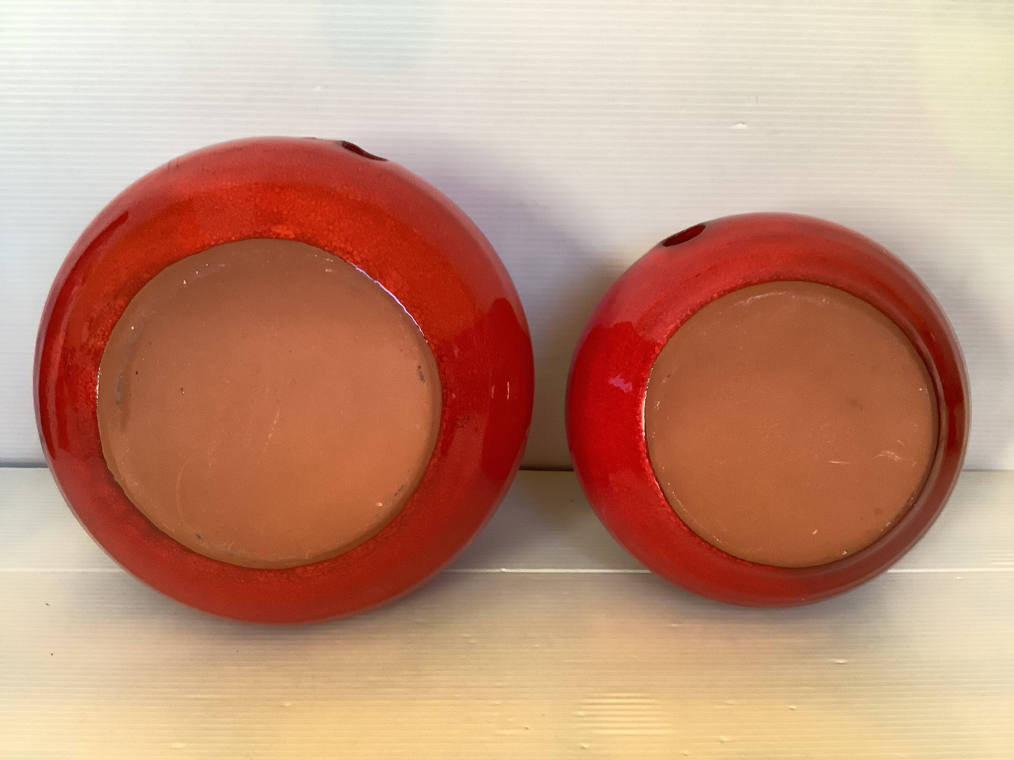 Pair of red Scandinavian candle holders.