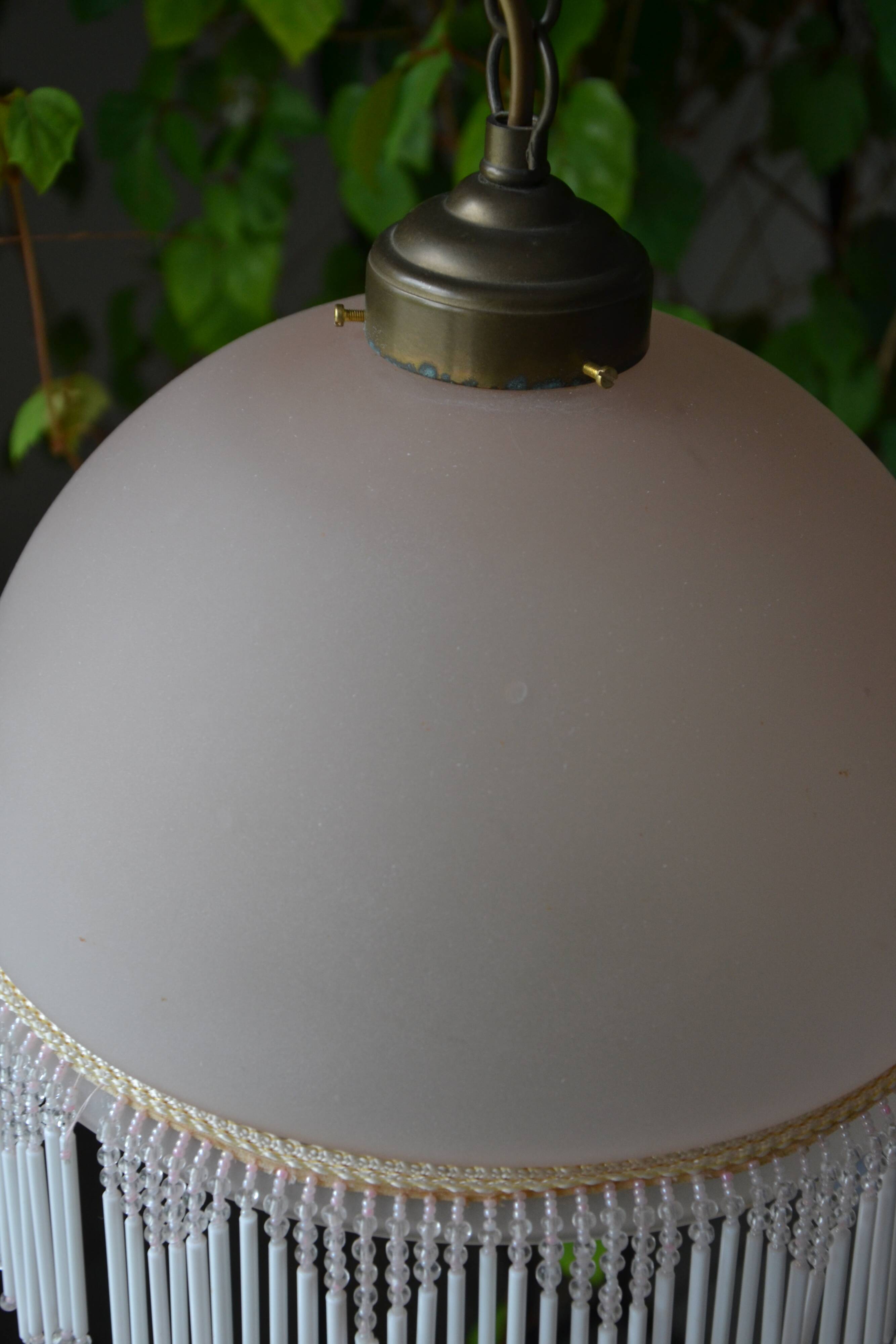 Lustrous suspension in glass paste, glass and ceramic pendants.