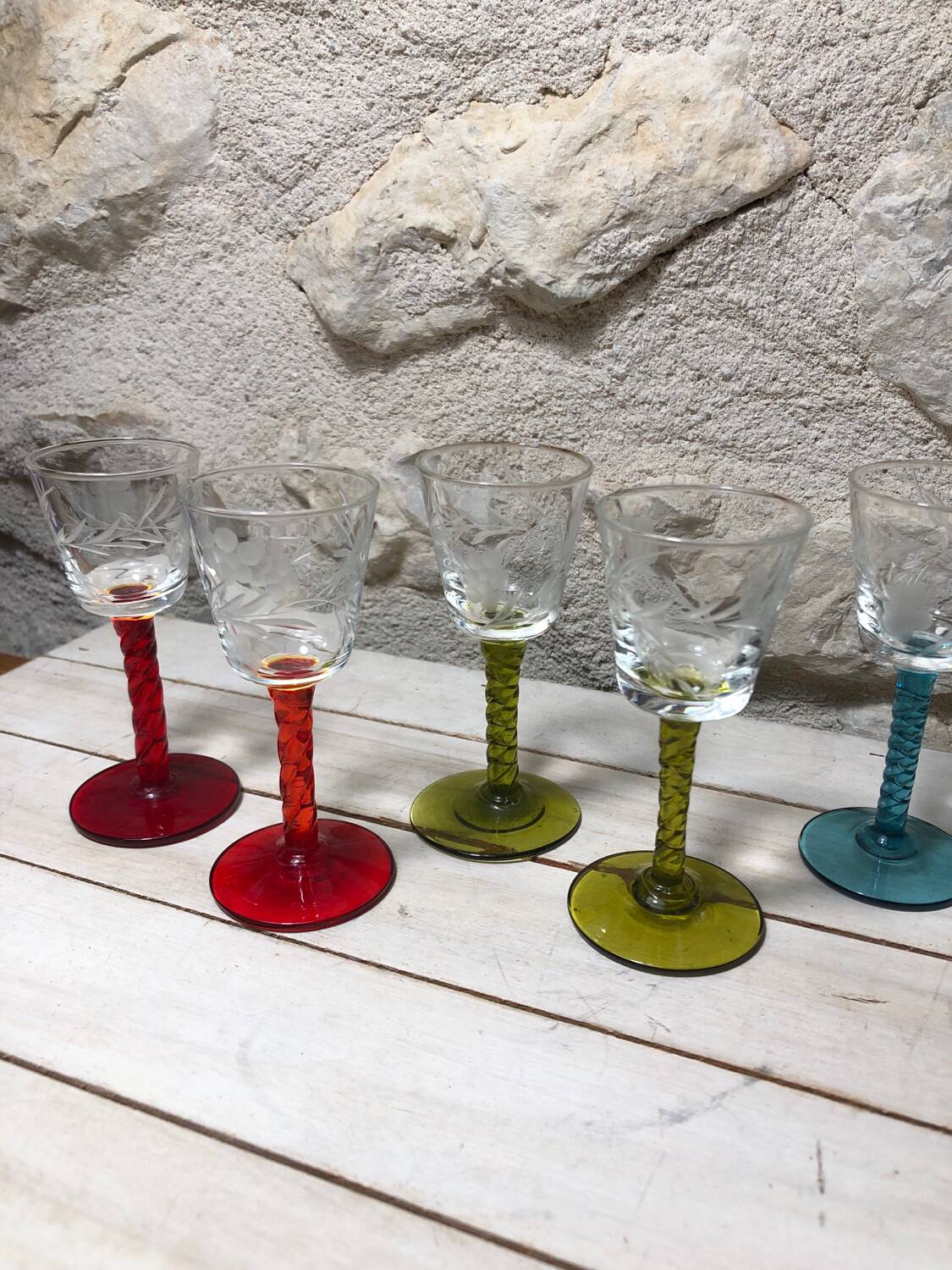 Antique and rare! Sold in a set of 12 colorful twisted stemmed glasses engraved with flowers and leaves