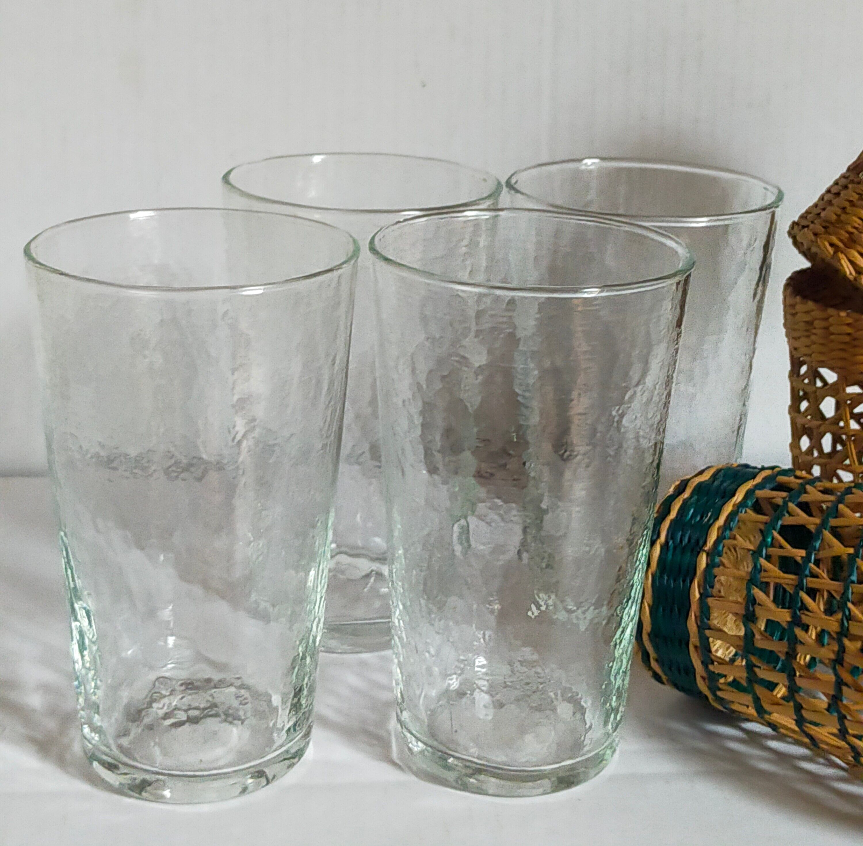 Four long drink glasses in vintage woven rattan cases