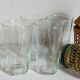 Four long drink glasses in vintage woven rattan cases