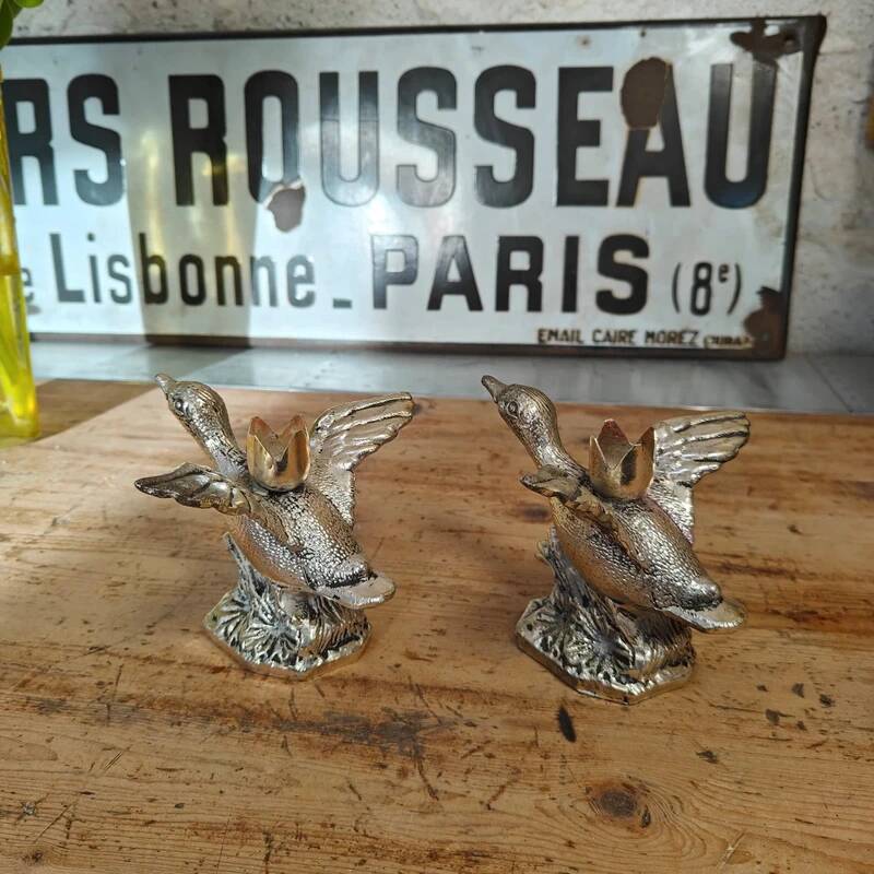 Set of two antique silver-plated duck candlesticks.