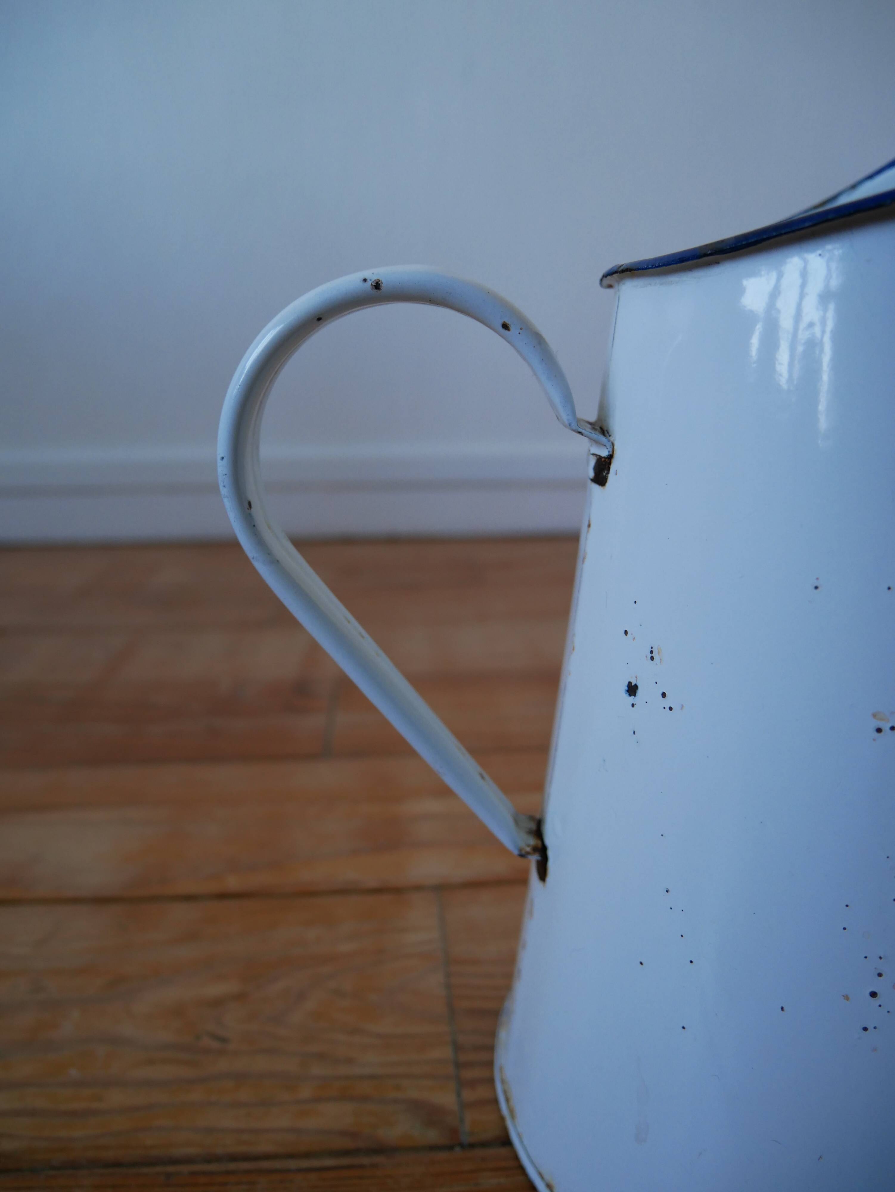 White enamelled metal broc