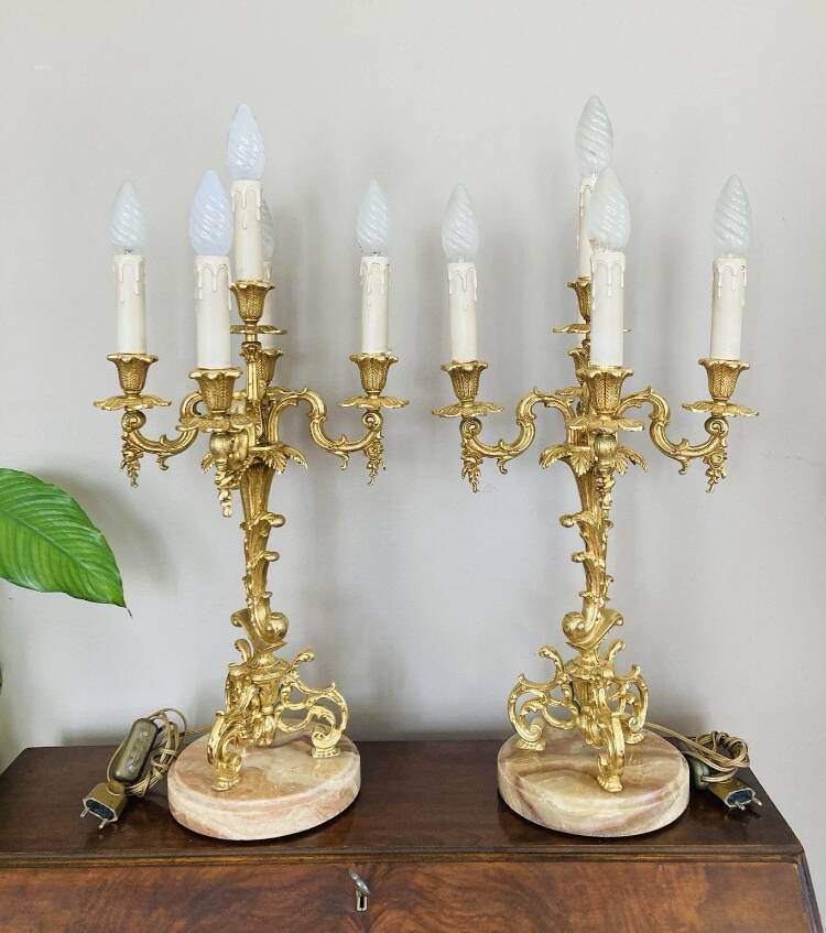 Pair of gilt bronze chandeliers, marble bases.