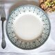 Mismatched antique flat plates made of ironstone pottery.