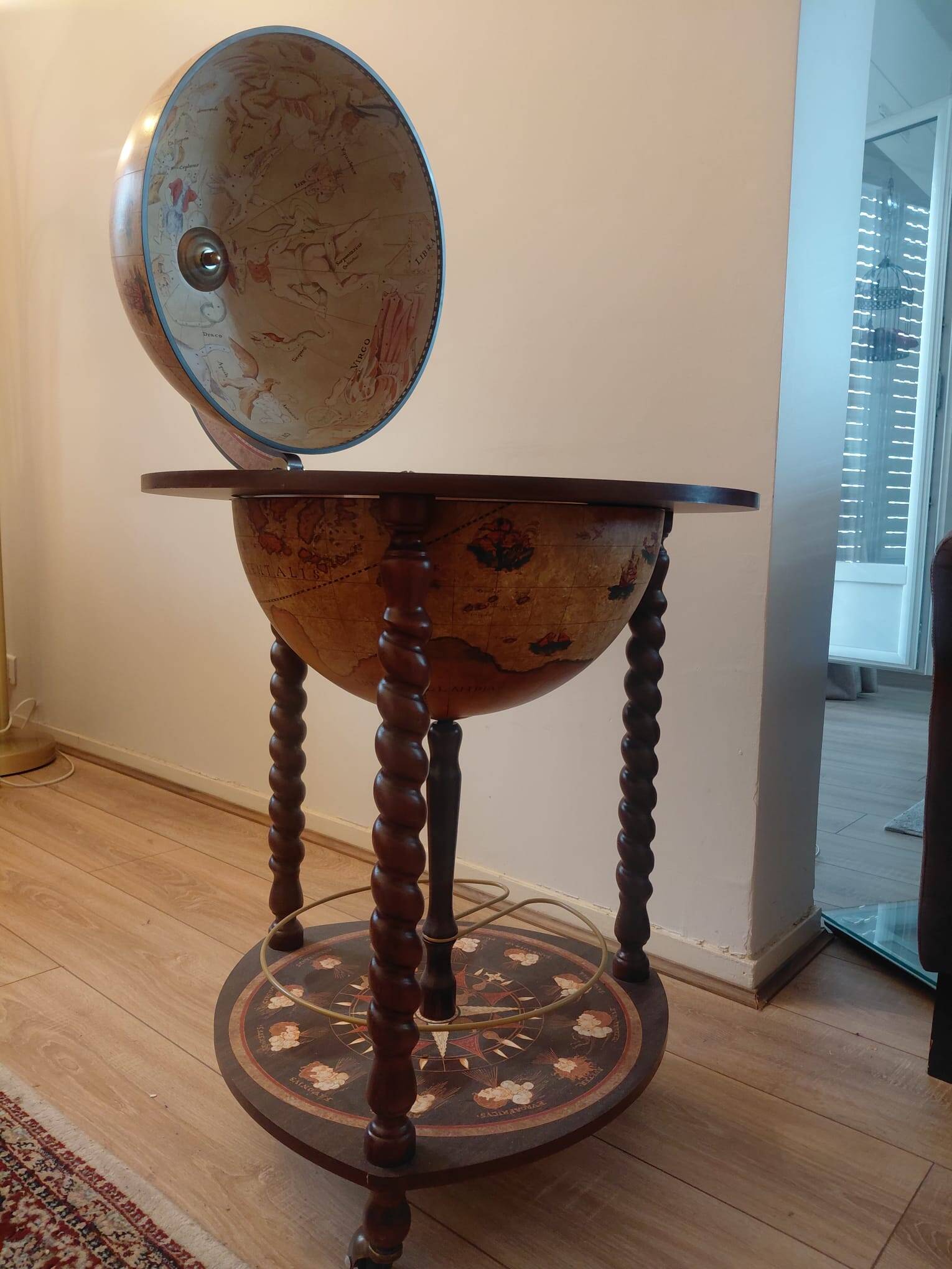 Vintage globe bar with storage for bottles and glasses.