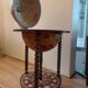 Vintage globe bar with storage for bottles and glasses.