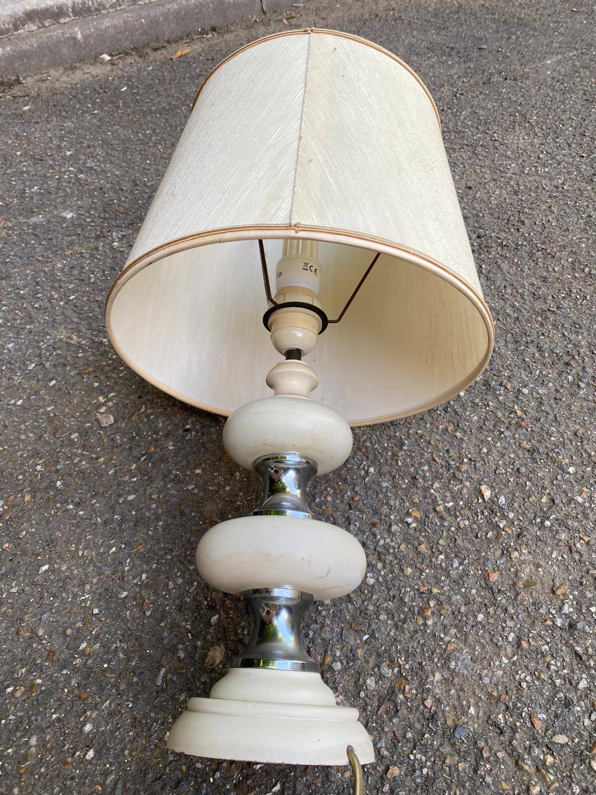 Space age bedside lamp in off-white wood with a metal band.