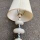 Space age bedside lamp in off-white wood with a metal band.