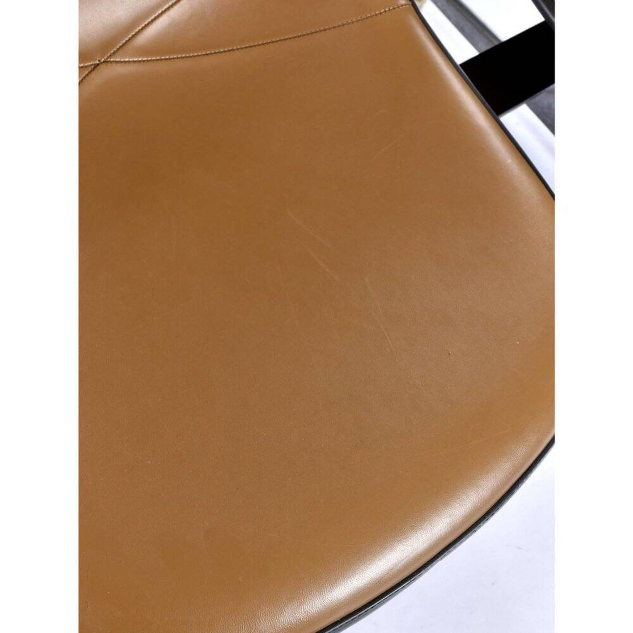 Tandem bench with brown Naugahyde pad shell chairs by Charles and Ray Eames for Herman Miller