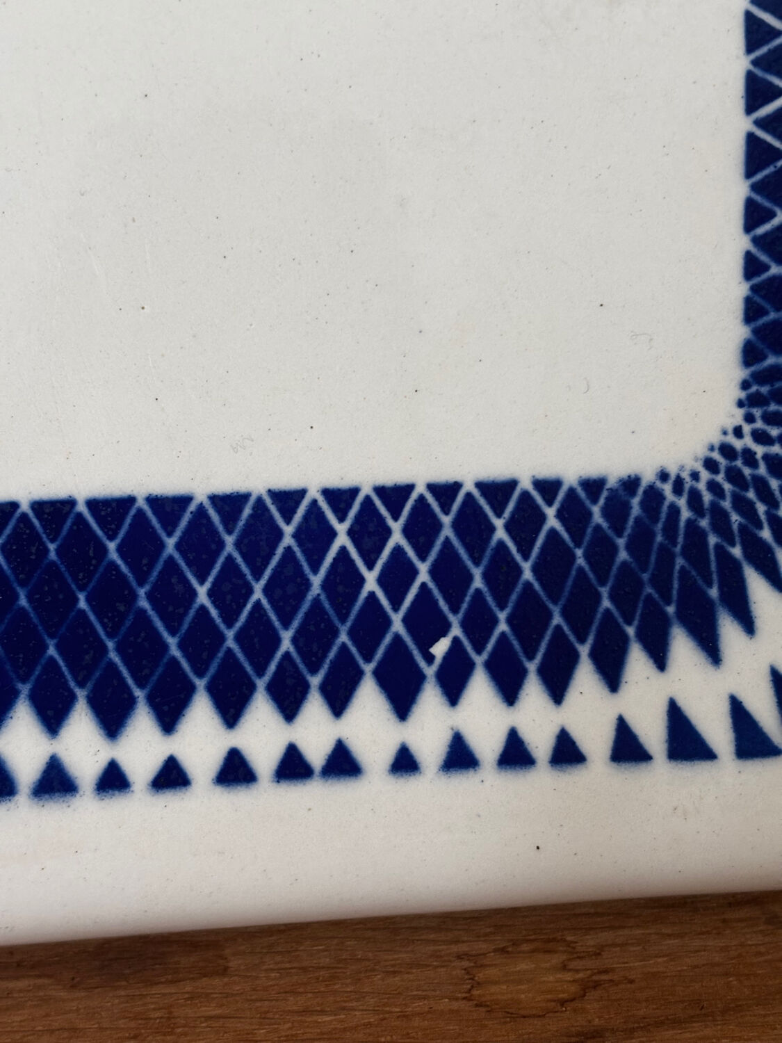Vintage old trivet Badonviller blue graphic pattern