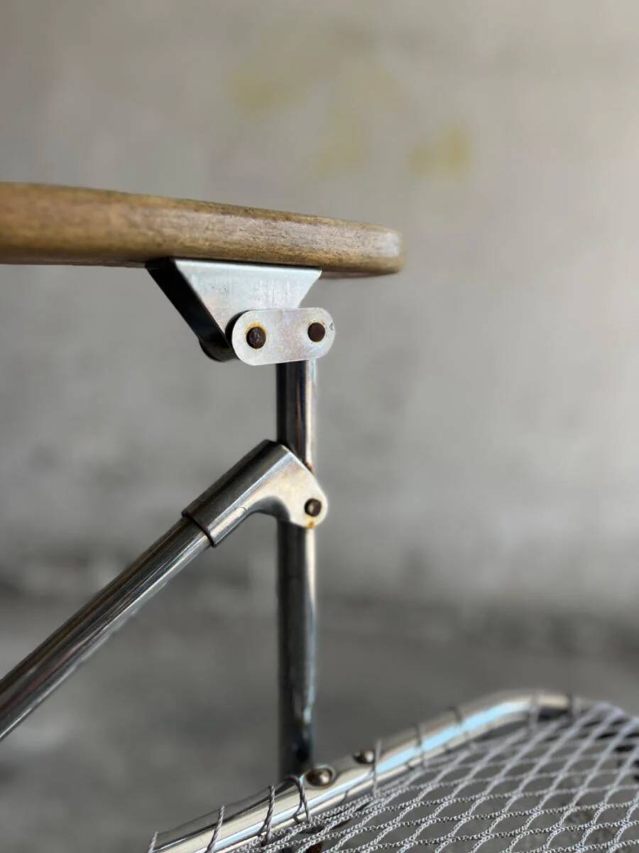 Pair of vintage silver aluminum wire folding chairs with wooden armrests — industrial minimalist