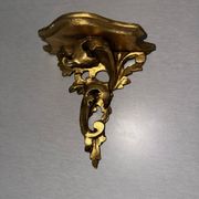 Antique wall-mounted console in gilded wood in rococo style.