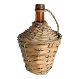 Circled with wicker demijohn
