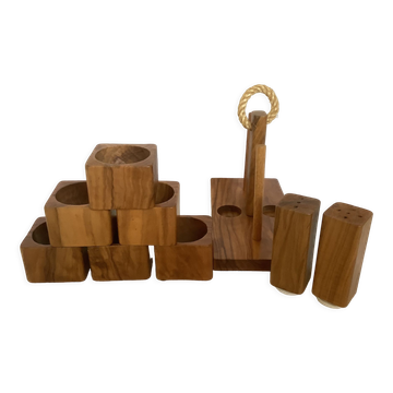 Six olive wood salt and pepper egg cups with their holder.